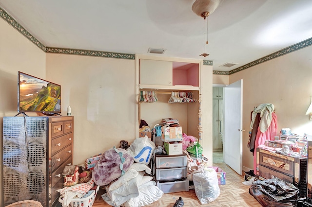 bedroom with ceiling fan and light parquet floors