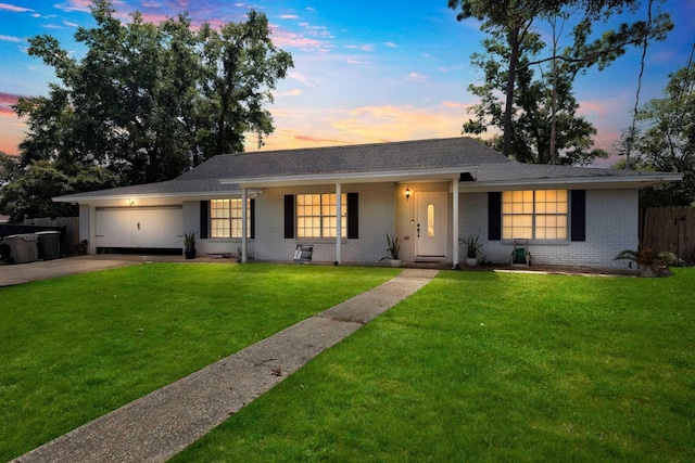 ranch-style home with a lawn and a garage