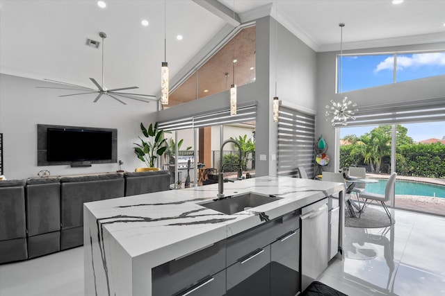 kitchen featuring high vaulted ceiling, sink, ceiling fan, an island with sink, and beam ceiling