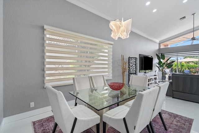 tiled dining room with crown molding, vaulted ceiling, and ceiling fan