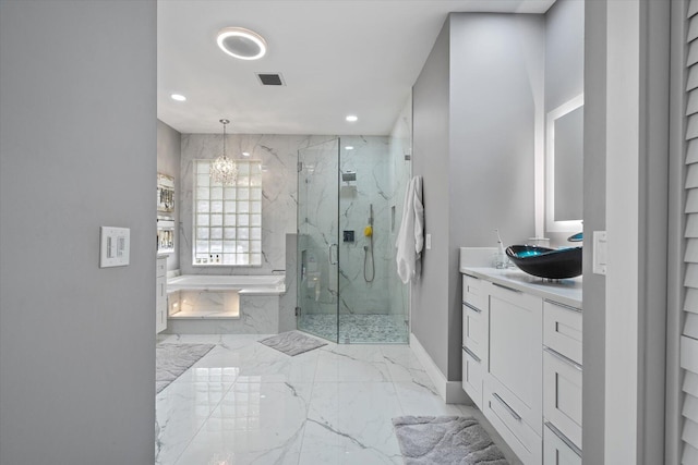 bathroom with tile patterned floors, separate shower and tub, an inviting chandelier, and vanity