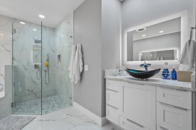 bathroom with a shower with door, vanity, and tile patterned flooring