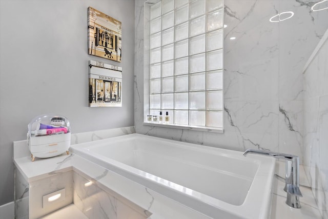 bathroom with tiled bath