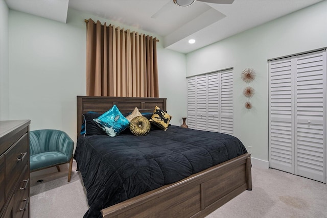 carpeted bedroom featuring ceiling fan and a closet