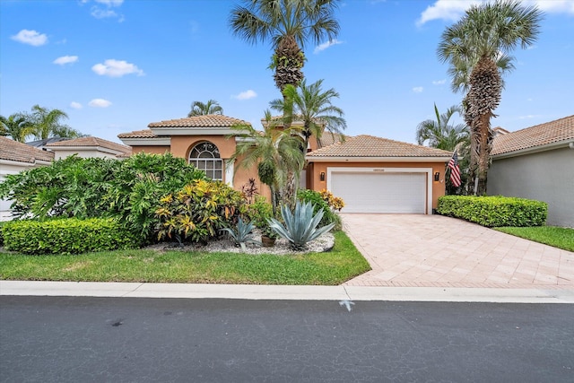 mediterranean / spanish-style house with a garage