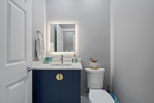 bathroom featuring toilet and vanity