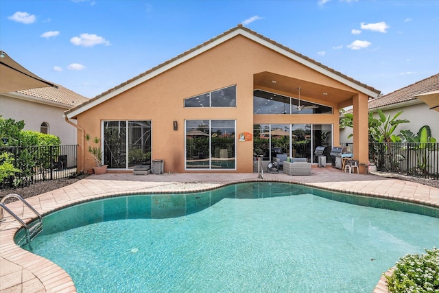 view of pool with ceiling fan and a patio area