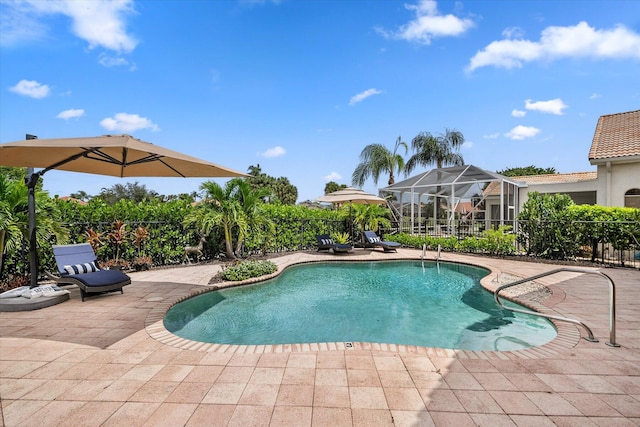 view of swimming pool featuring a lanai and a patio