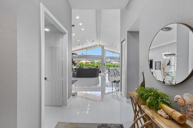 foyer entrance with vaulted ceiling and light tile patterned floors