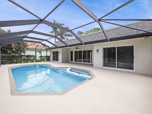 view of pool featuring glass enclosure, a patio area, and a pool with connected hot tub