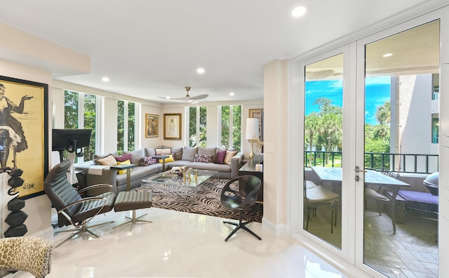 tiled living room featuring ceiling fan and french doors