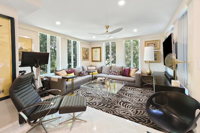 living room with a wealth of natural light and ceiling fan