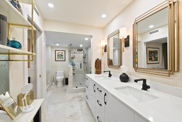 bathroom with vanity, toilet, and a shower with door