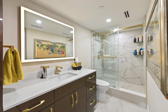 bathroom with vanity, toilet, a shower with shower door, and tile patterned flooring