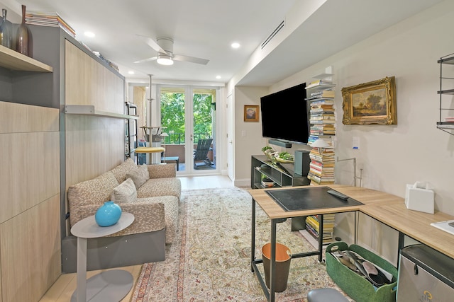 living room featuring ceiling fan and french doors