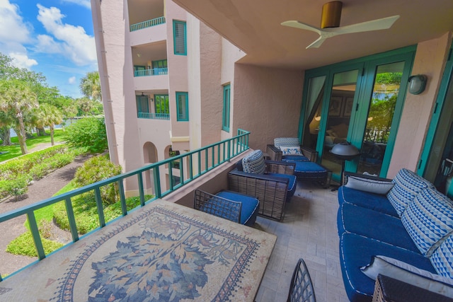 view of patio / terrace with a balcony and ceiling fan