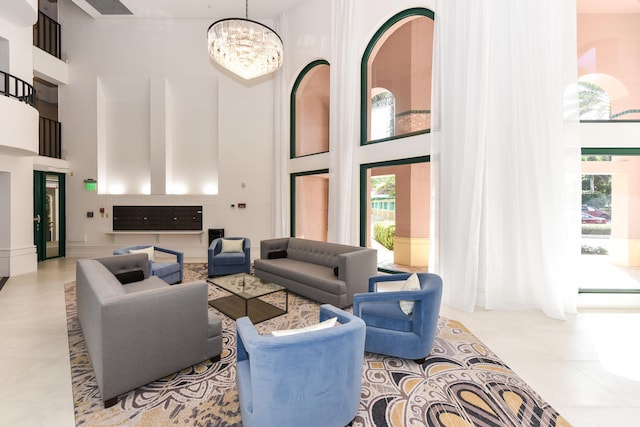 tiled living room with a towering ceiling and a notable chandelier