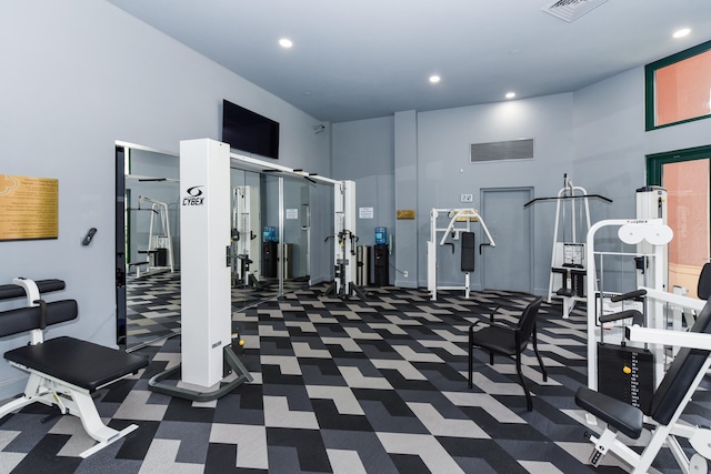 exercise room with a high ceiling