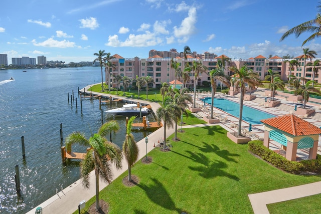 exterior space with a patio area, a yard, a community pool, and a water view