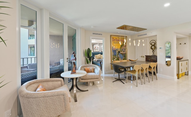 living area featuring light tile patterned floors and an inviting chandelier