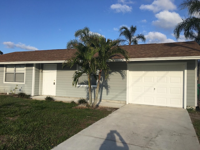 view of front facade with a garage and a front yard