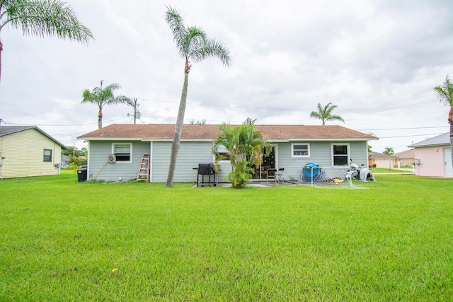 back of property featuring a lawn