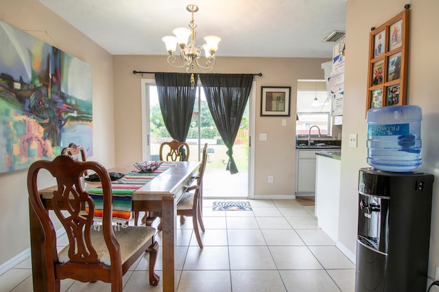 dining space with light tile patterned flooring, sink, and a chandelier