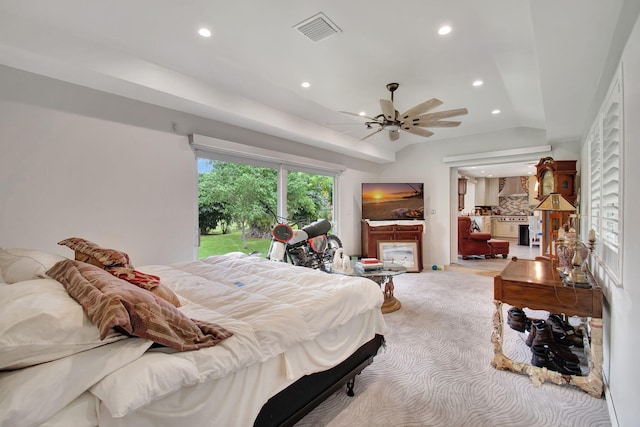 bedroom featuring ceiling fan, light colored carpet, and lofted ceiling