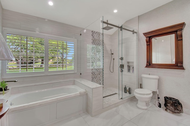 bathroom with tile patterned floors, shower with separate bathtub, and toilet