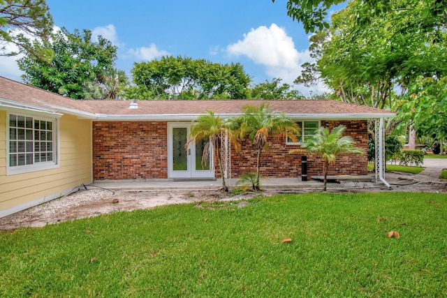 back of house featuring french doors and a yard