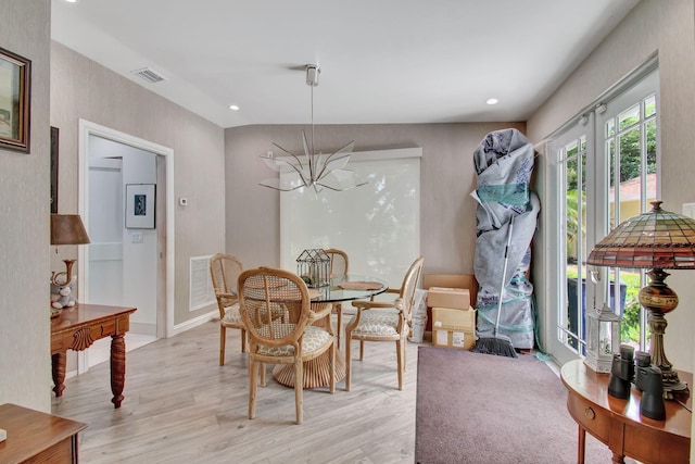 dining space with light hardwood / wood-style flooring and lofted ceiling