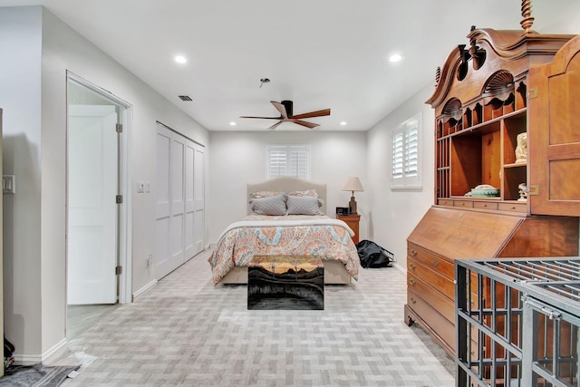 bedroom featuring ceiling fan, a closet, and light carpet