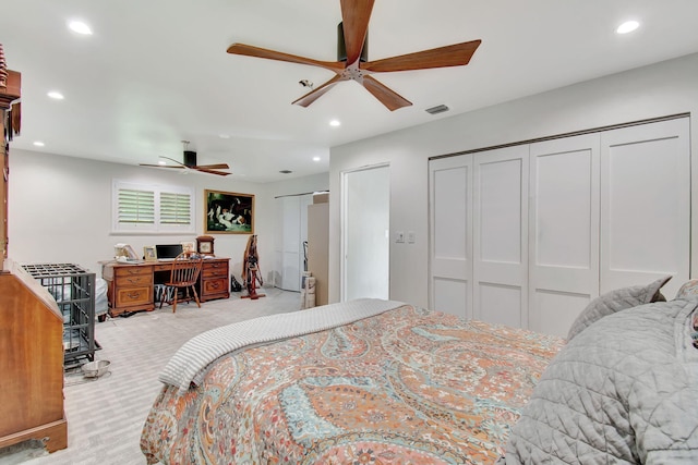 carpeted bedroom with ceiling fan and multiple closets