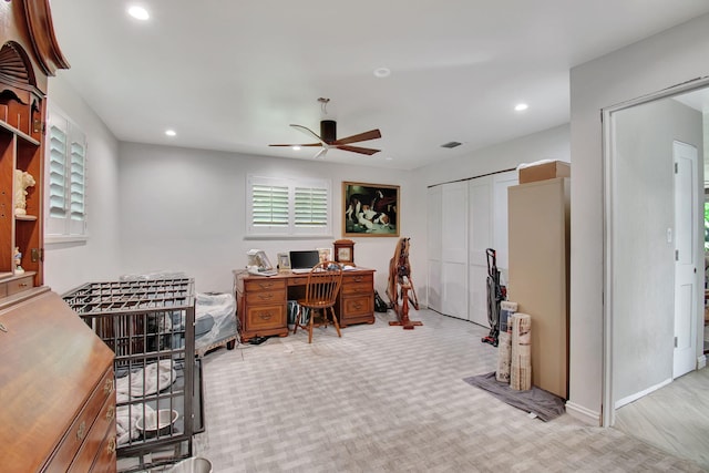 carpeted office with ceiling fan