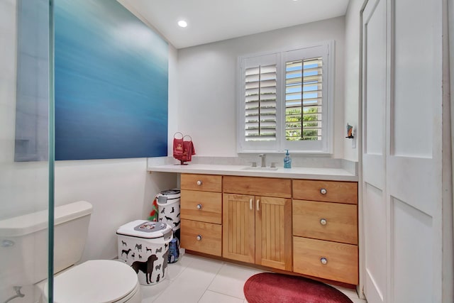 bathroom featuring tile patterned flooring, toilet, and vanity