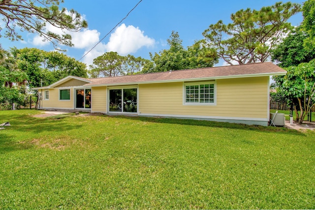 rear view of property with a yard