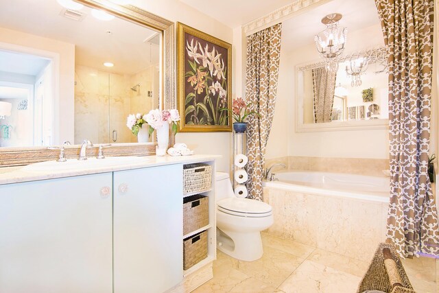 full bathroom with a chandelier, vanity, tile patterned floors, toilet, and separate shower and tub