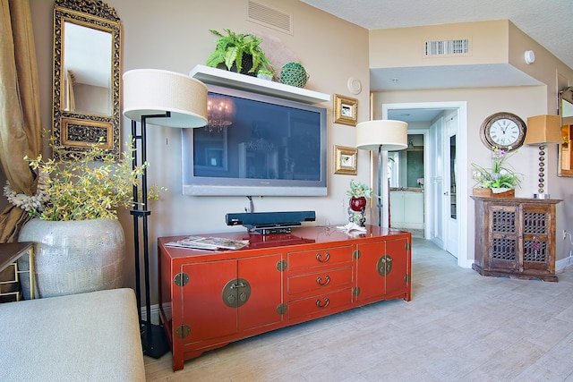 interior space with light wood finished floors, visible vents, and baseboards