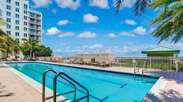 community pool featuring a patio area and fence