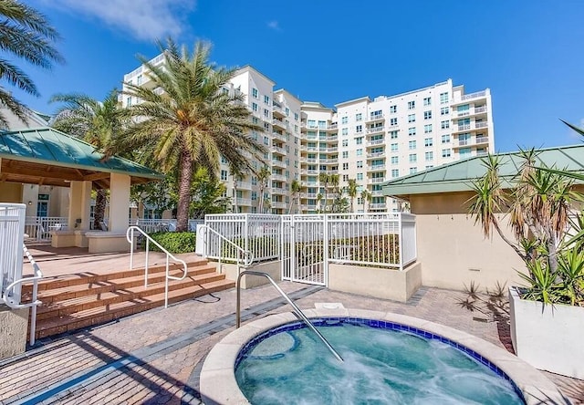 view of swimming pool featuring a patio area, fence, a hot tub, and a gazebo