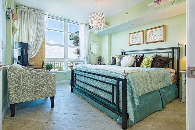 bedroom featuring light hardwood / wood-style floors and an inviting chandelier