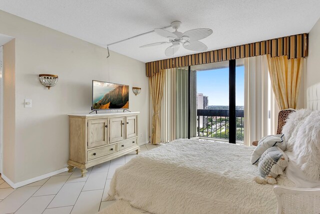 bedroom with ceiling fan, access to exterior, and light tile patterned floors