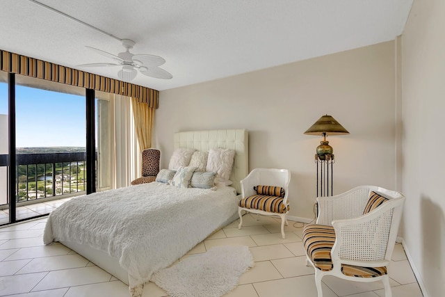 bedroom featuring light tile patterned floors, a textured ceiling, ceiling fan, baseboards, and access to outside