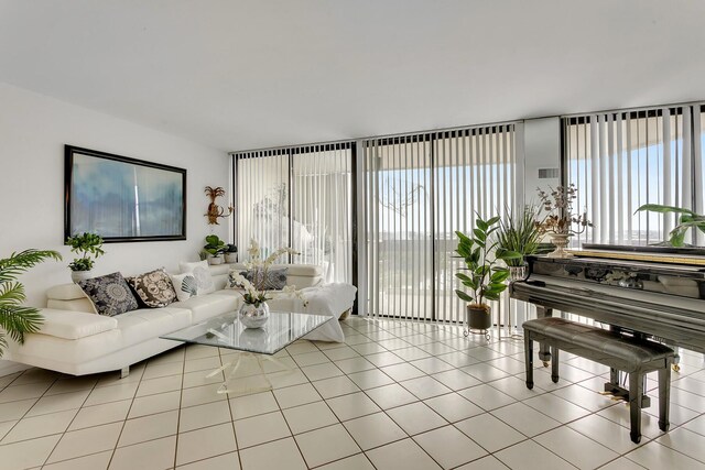 living room featuring light tile patterned flooring and floor to ceiling windows