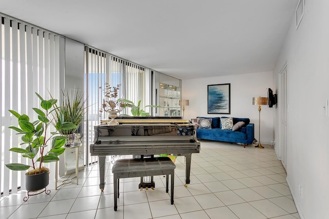 living area with visible vents and light tile patterned flooring