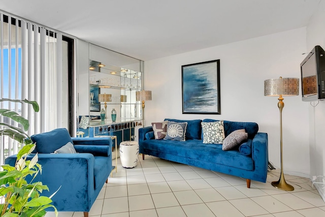 living room featuring expansive windows and light tile patterned flooring