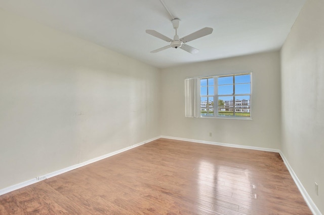 unfurnished room featuring hardwood / wood-style floors and ceiling fan