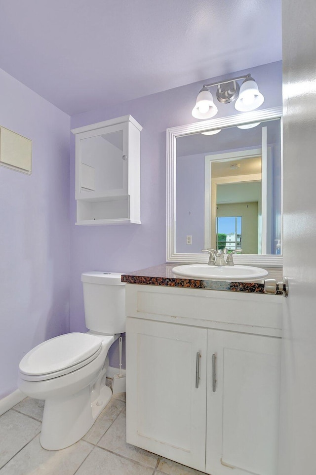 bathroom featuring tile patterned floors, toilet, and vanity