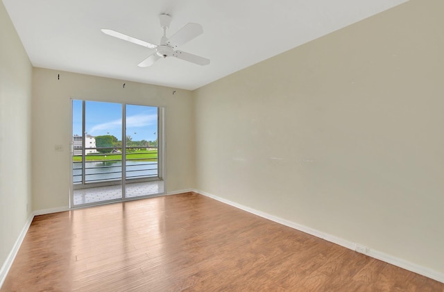 empty room with ceiling fan and wood-type flooring