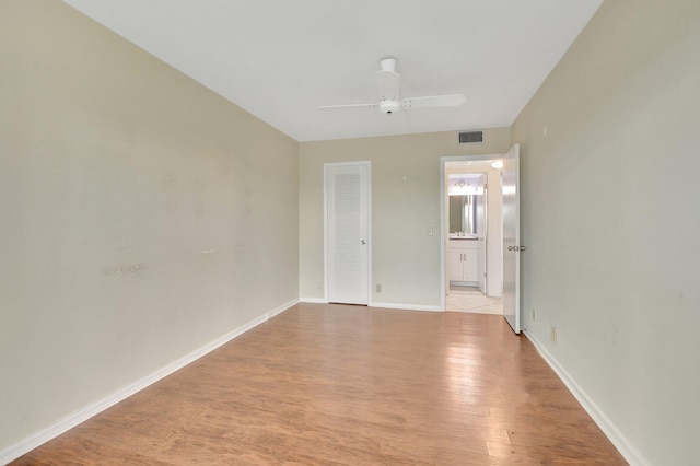 empty room featuring light wood-type flooring and ceiling fan